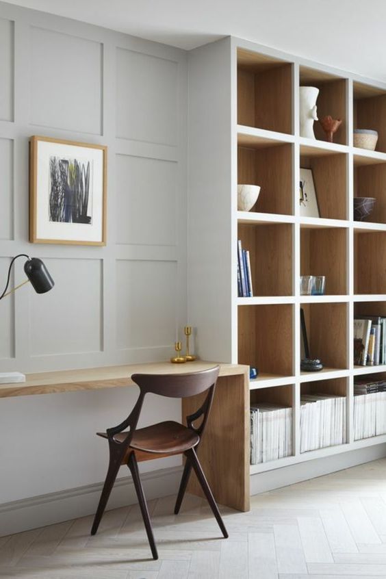 make a usual neutral wall chic and catchy with paneling like here and it will echo with built-in shelves