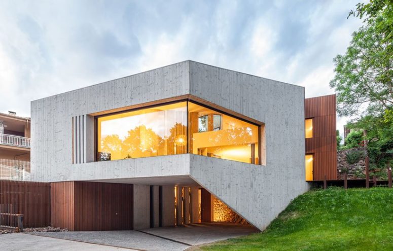 This chic contemporary home is built into a sloped site to establish a relationship with nature