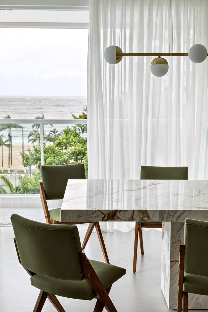 The apartment is done in neutrals, as there's a gorgeous view, one wall is glazed and that brings much natural light to the space