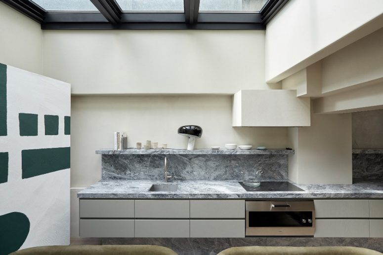The kitchen is done with a marble backsplash, a glass roof that can be opened to outdoors anytime