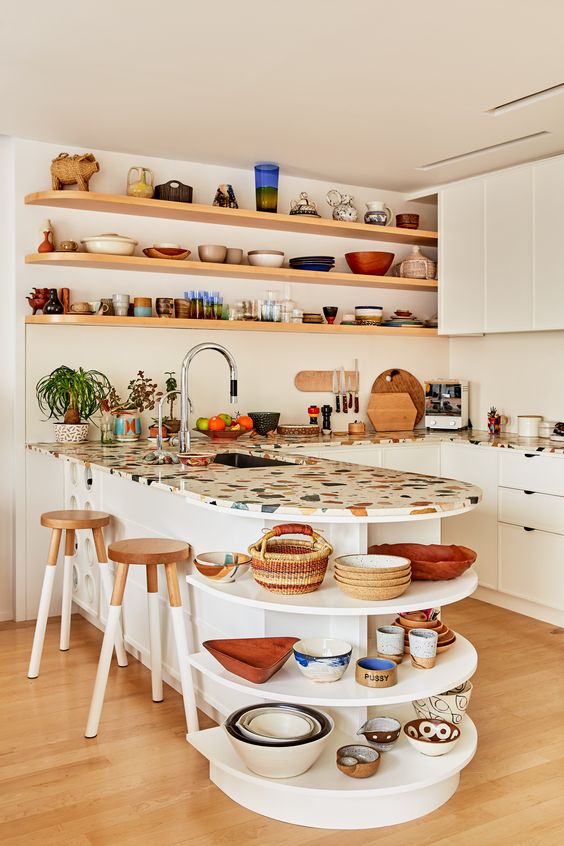 a neutral kitchen with a bright terrazzo countertop that adds color and a pretty pattern to the space