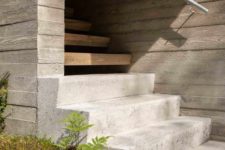 03 The entrance staircase is built of concrete and wood, with metal railing for a modern feel