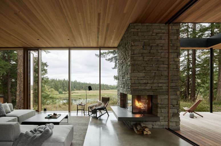 The living room is done with a ifreplace, a glazed wall and modern furniture and can be opened to outdoors The living room is done with a ifreplace, a glazed wall and modern furniture and can be opened to outdoors