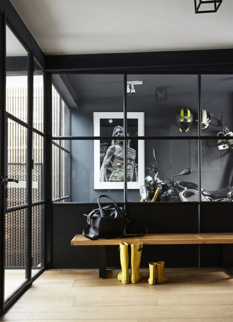 Statement artworks, a large mirror that fills the space with natural light, a wooden bench and a glass door make this nook cool Statement artworks, a large mirror that fills the space with natural light, a wooden bench and a glass door make this nook cool