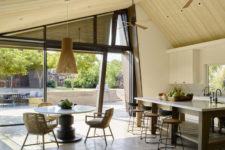 05 The kitchen is all-neutral, and there’s a small dining zone with a wooden pendant lamp