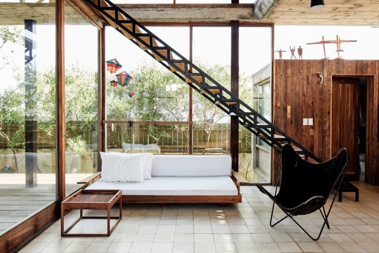 There's a living room with comfy furniture and stairs to the upper level