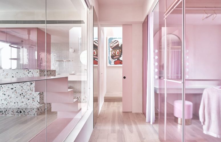Some spaces are divided only with glass partitions in pink to connect them and brign more light here Some spaces are divided only with glass partitions in pink to connect them and brign more light here