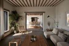 06 There’s an indoor living room with wooden and upholstered furniture