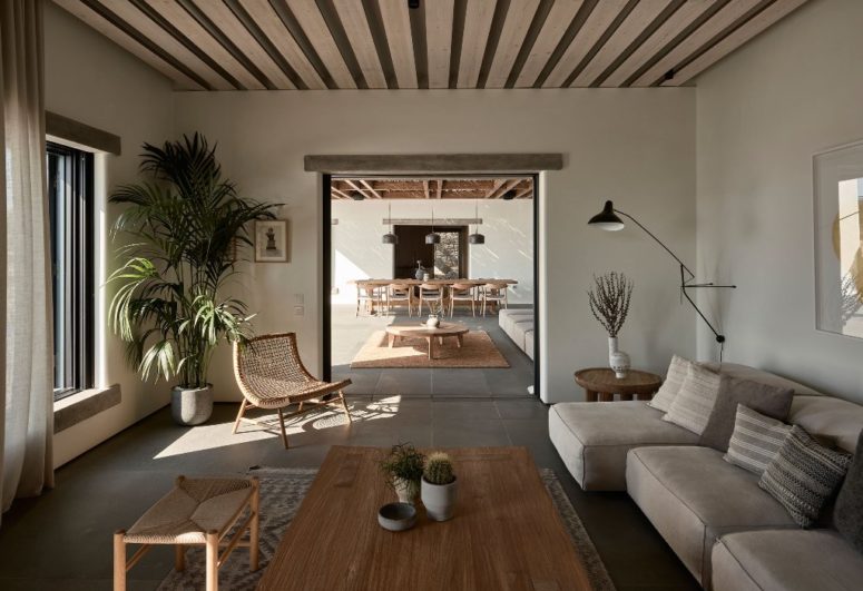 There's an indoor living room with wooden and upholstered furniture