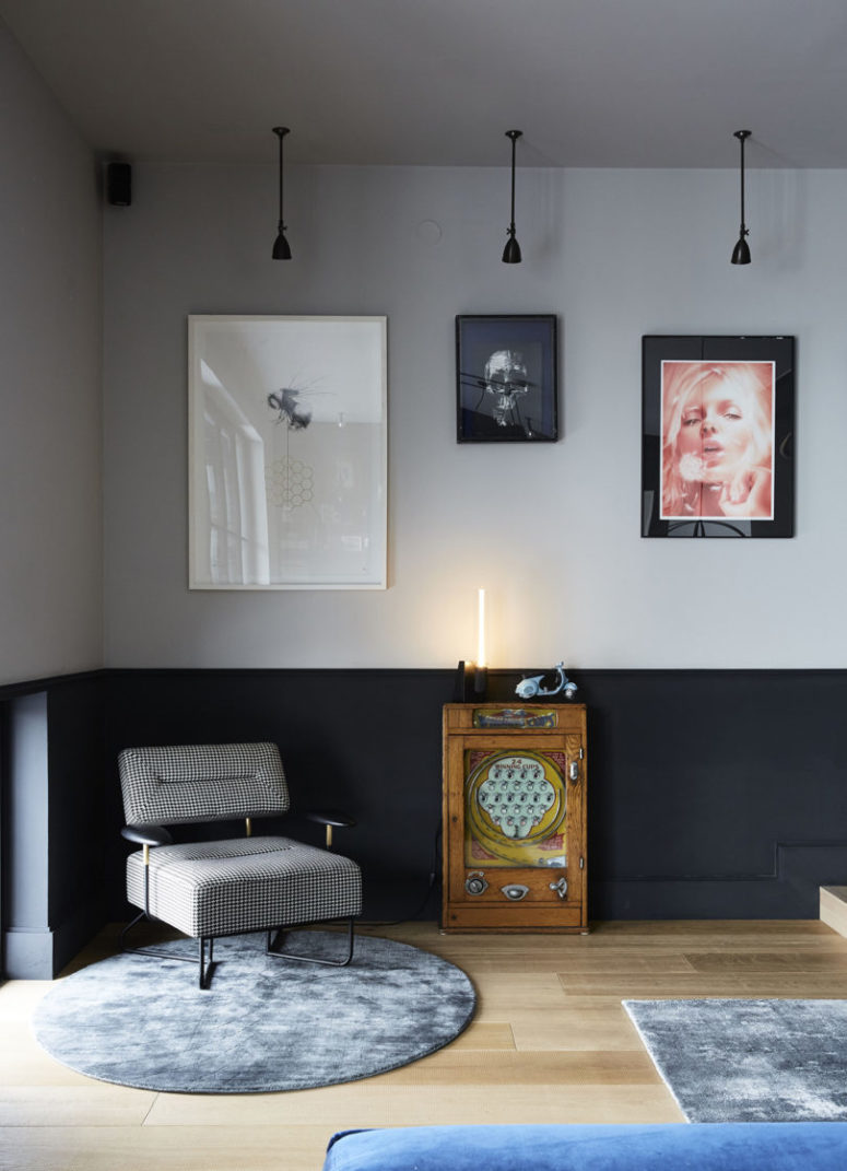 This nook features a unique gallery wall, pendant lamps, a little side table and a chic mid century modern chair This nook features a unique gallery wall, pendant lamps, a little side table and a chic mid-century modern chair
