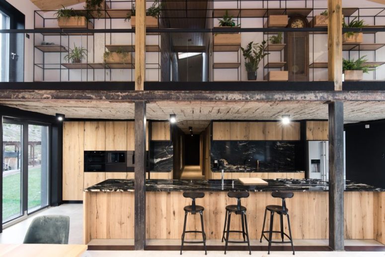 Lots of potted greenery refreshes the space and many shelves can be used for storage