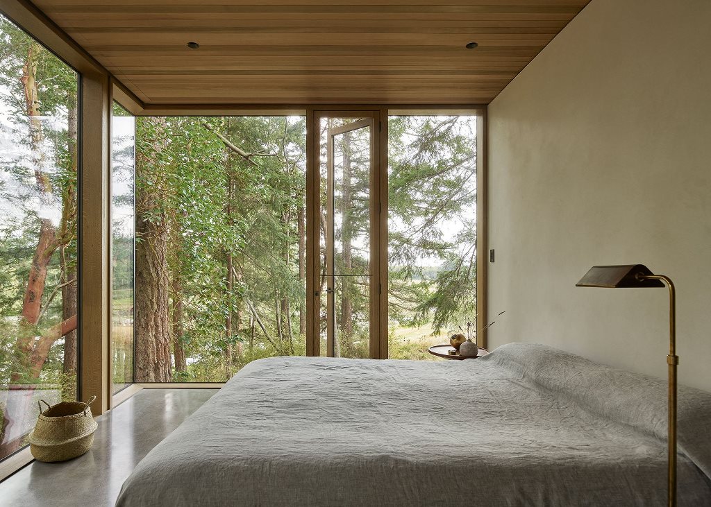 The bedroom shows off amazing views and simple modern furniture
