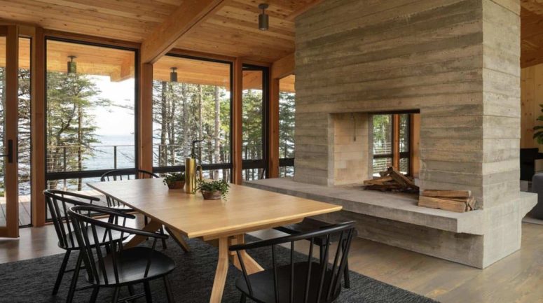 There's also a more formal dining space with black chairs and a double-sided fireplace that divides spaces