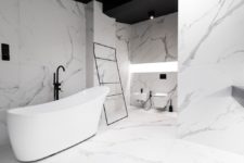 10 The bathroom is clad with large scale marble tiles, everything is very minimal and refined here