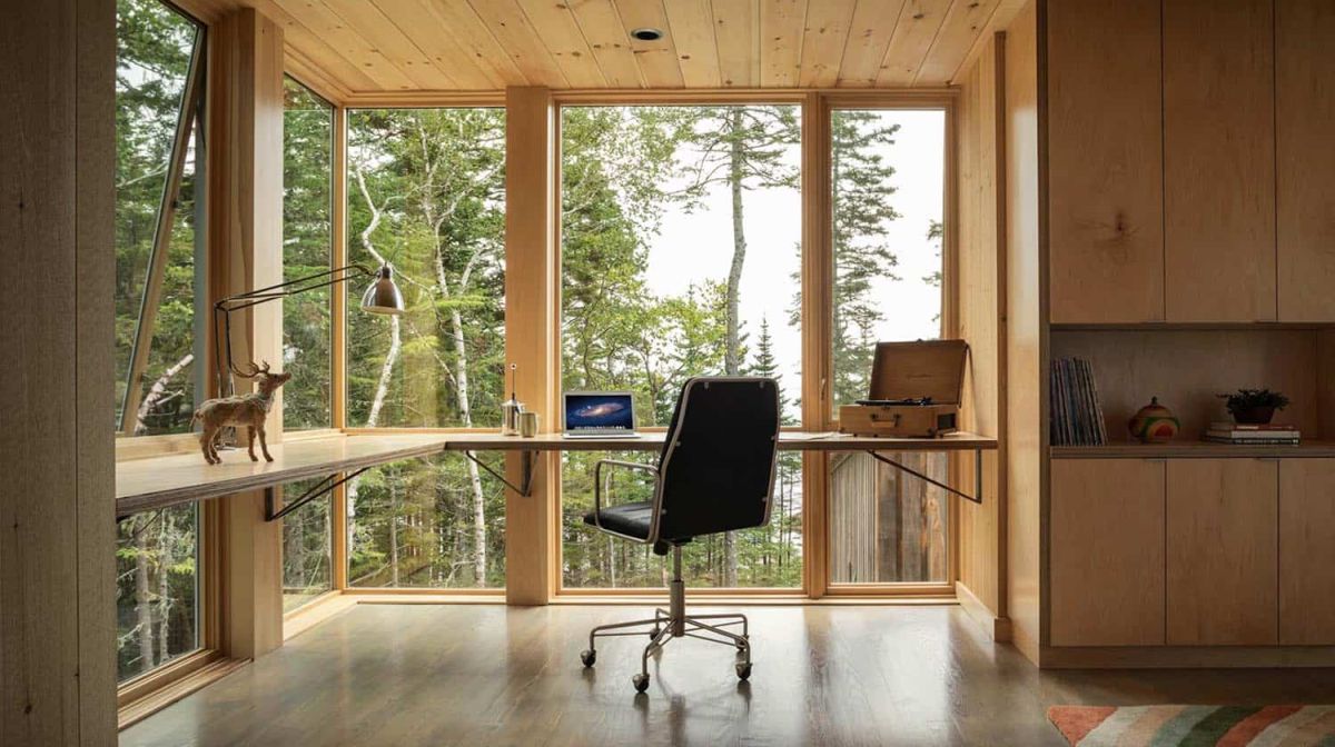 This modern floating desk takes full advantage of the floor to ceiling windows and the abundance of natural light