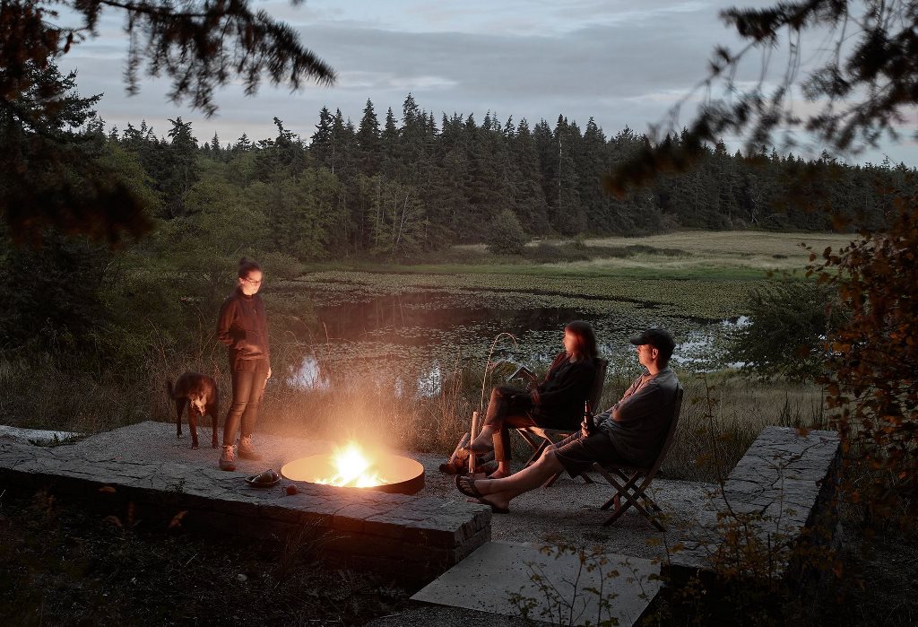 There's a terrace with a firepit and a large and forest view