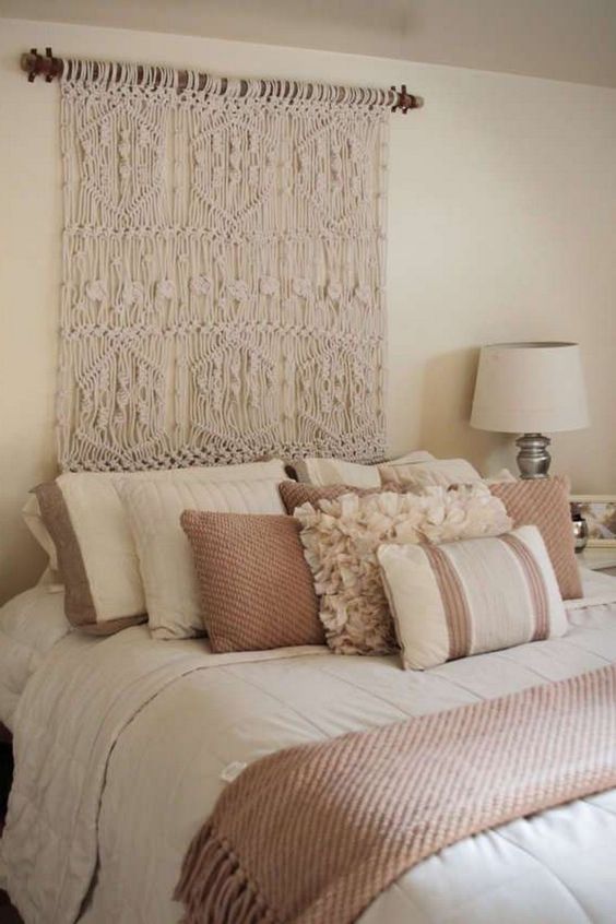 a macrame wall hanging instead of a usual headboard is a creative idea to go for