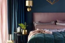 a beautiful bedroom in teal and dusty pink, with a pink bed and bedding, a gold chandelier and sconces for a wow look