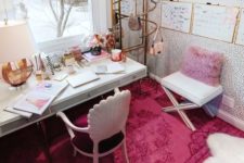 a bold glam home office with a lavender pillow, a hot pink rug, some pink accessories and touches