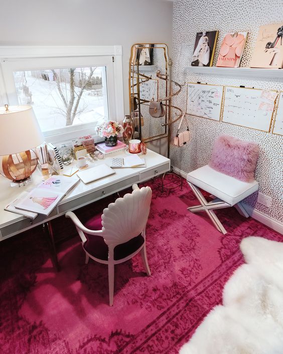 a bold glam home office with a lavender pillow, a hot pink rug, some pink accessories and touches