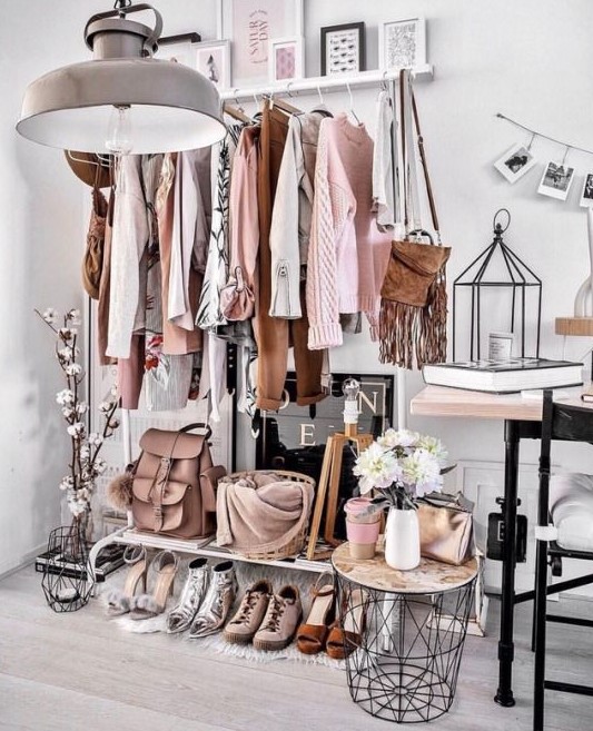 a chic makeshift closet with a railing for hanging it, a shoe shelf and a side table is great if you don't have many things