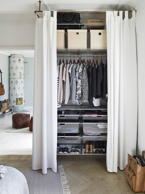 a closet with sheer drawers and shoe shelves, a makeshift closet and shelves for bags and boxes for storage