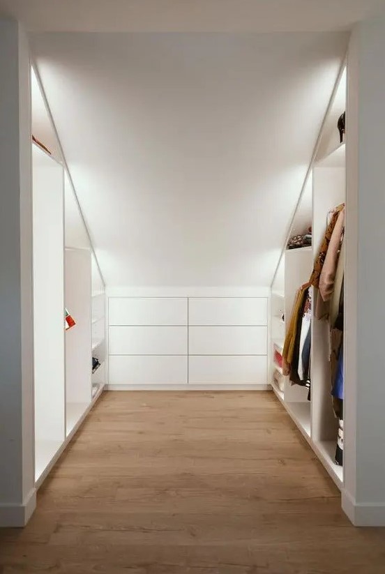 a cool modern attic ceiling closet with open shelves with built-in lights and a built-in dresser is a very practical solution