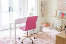 a cute eclectic home office with a hot pink chair, floral printed pink rug and some more accessories that add a girlish feel