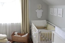a neutral and peaceful nursery with dove grey walls, yellow curtains, grey and yellow bedding and a cute gallery wall