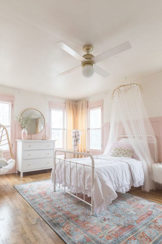 a romantic and airy girlish bedroom with pink panaled walls, a pink vase and window frames