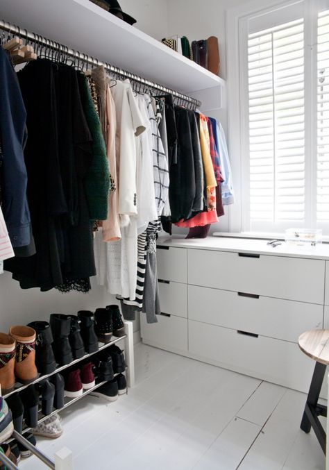 a small Scandinavian closet with a couple of drawers, a makeshift closet and shoe shelves, a shelf with bags is a cool idea