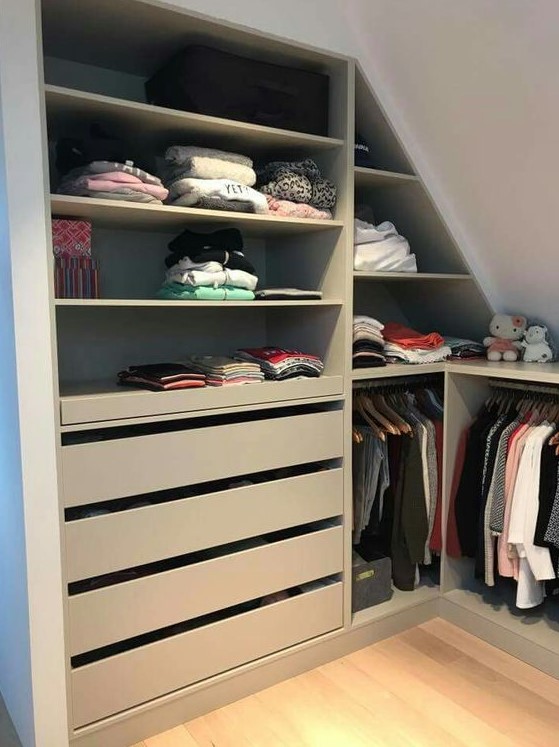 a small attic closet with grey storage units, drawers and railing plus toys is a lovely idea for a kids' space