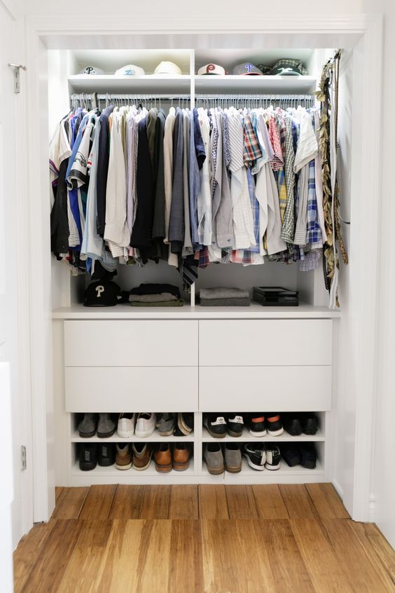 a small built-in closet with open shelves, drawers and rails with hangers is a perfect way to store a lot of things