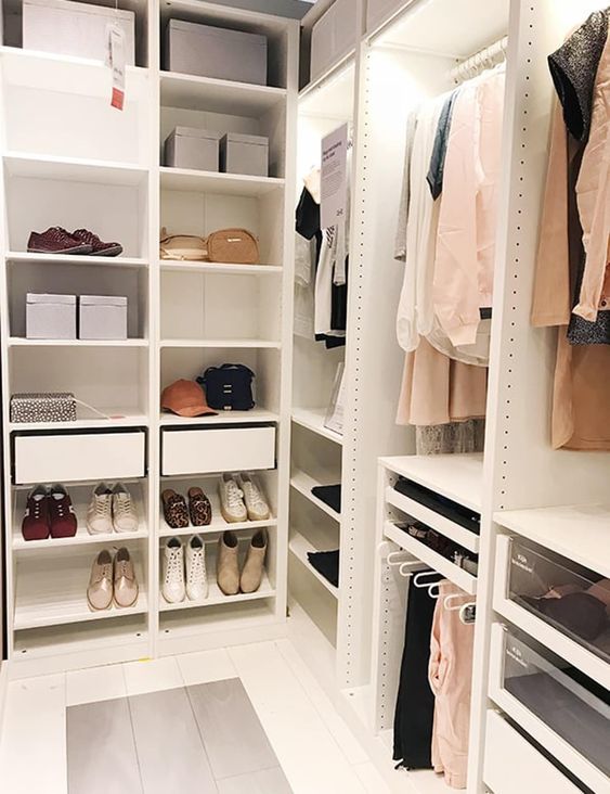 a small closet with open shelving, drawers, lights and some boxes is a very cool idea for anyone
