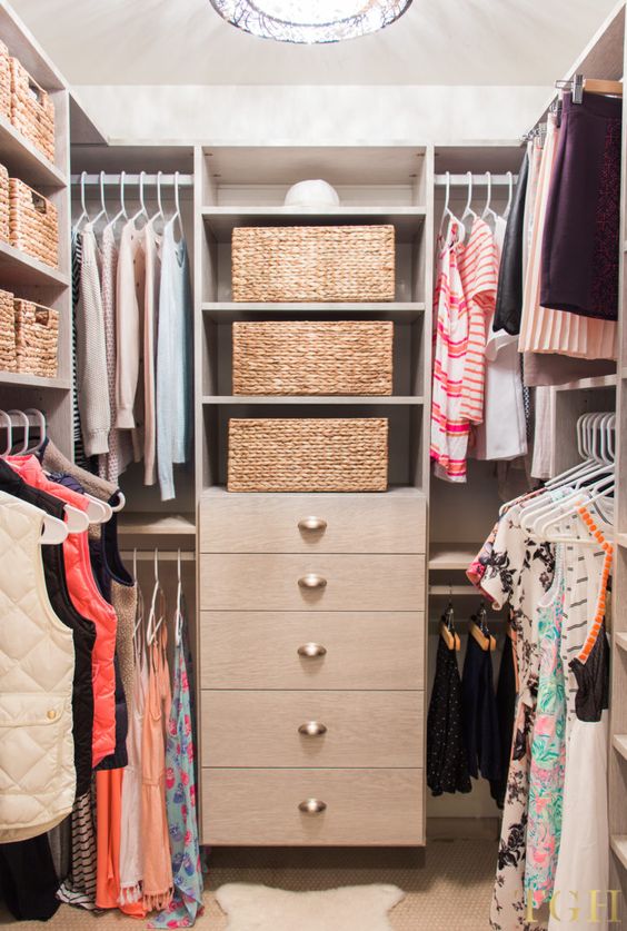 a small cozy closet with open shelves and rails, a dresser and baskets for storage is a cool space to store your things