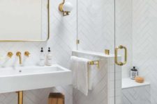 a small monochromatic bathroom with white herringbone tiles, printed black ones on the floor and touches of gold