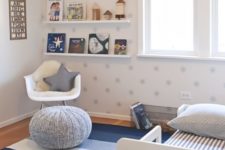 a starry nursery with a star printed wall, blue textiles, an open shelf and lots of toys and books