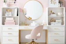 a stylish glam home office with a pink color block wlal, pink accessories and a chair and touches of gold