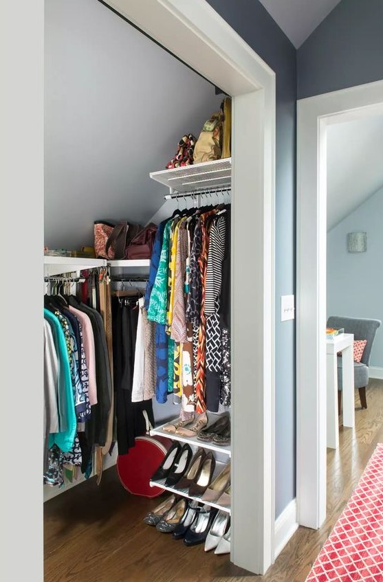 a tiny attic walk-in closet with railings and shelves, with shoe shelves is a cool idea if you don't have much space