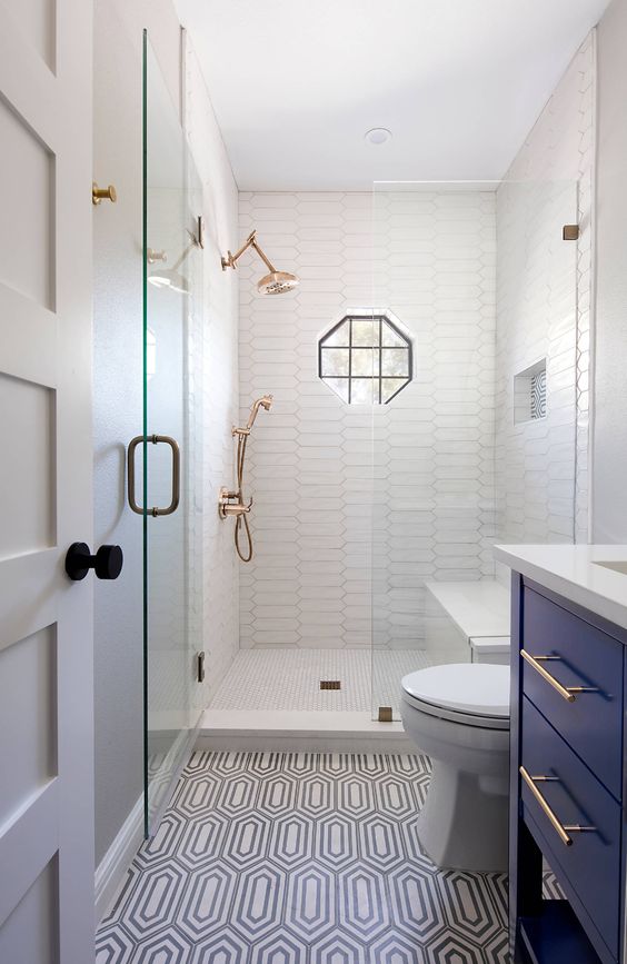 https://www.digsdigs.com/photos/2020/05/a-tiny-bathroom-with-white-and-printed-tiles-a-navy-vanity-white-appliances-brass-fixtures-and-black-touches.jpg