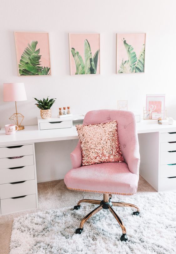 a tropical-inspired home office with a pink chair, a pink gallery wall and some more accessories in this amazing color