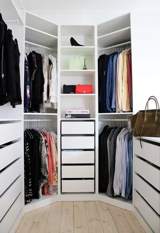 a white hexagon-shaped closet with drawers and open shelves and a window is a lovely space to store clothes and shoes