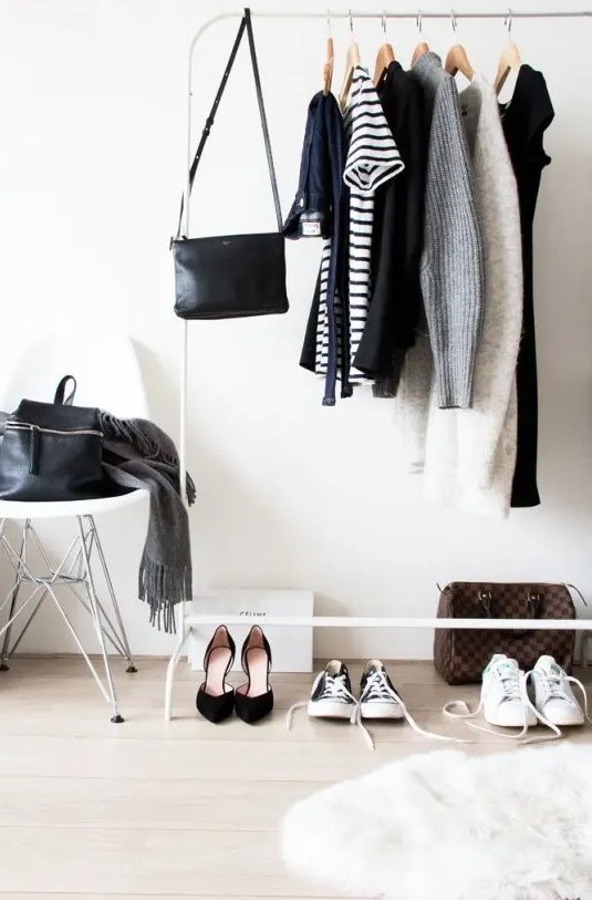 a white makeshift closet and a stool are all you need for a small wardrobe, the space feels Scandinavian