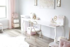 an airy and ethereal home office with white walls, pink curtains, pink furniture and some accessories plus a crystal chandelier