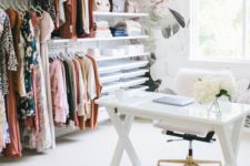 an airy and girlish home office with a floral wallpaper wall, a vast makeshift closet with open shelving, a trestle desk and a white fur chair