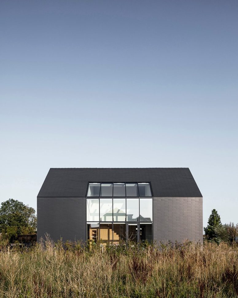 This black barn like minimalist home makes a statement in the farmland region of Netherlands