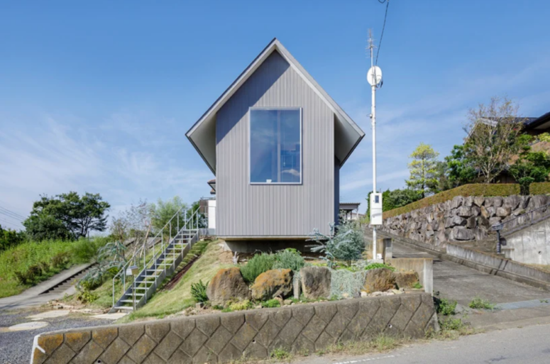 This minimalist Japanese home is built into a hill and features foundations at three different heights