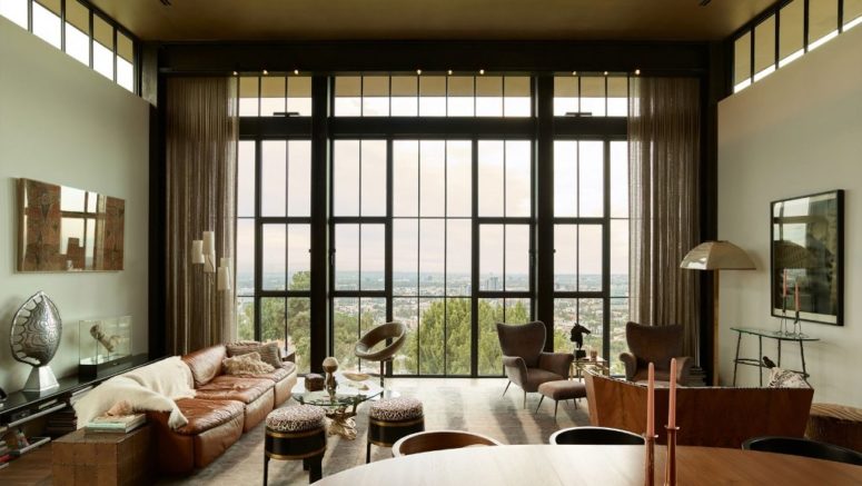 The color palette is warm and cool, with many neutrals and cool materials like leather, wood, stone