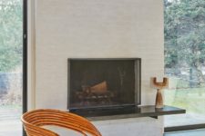 02 The walls are covered with white plaster, the fireplace is done with brick, and the floor is dark