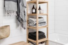 02 a minimalist wooden shelf with towels and various necessary bathroom stuff and railing for towels over it